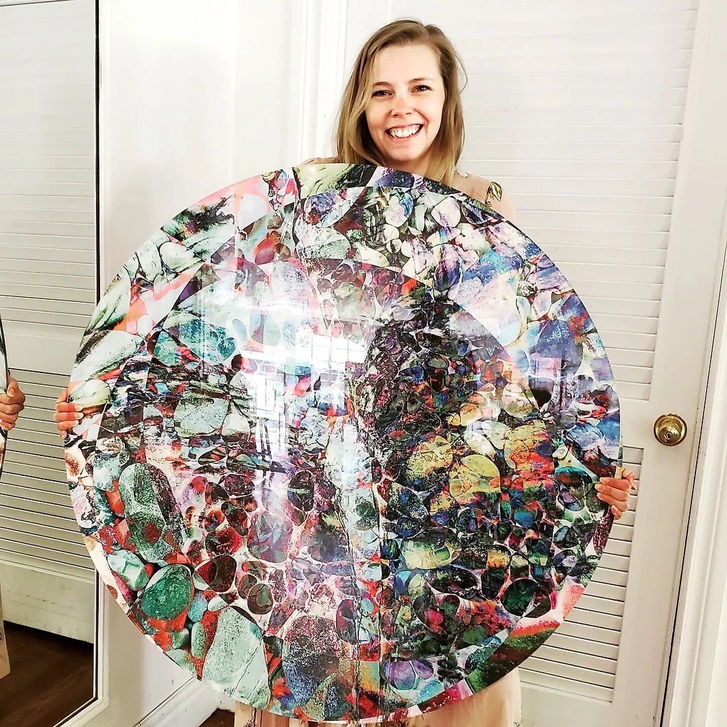 Kezleigh holding a large round acrylic piece
