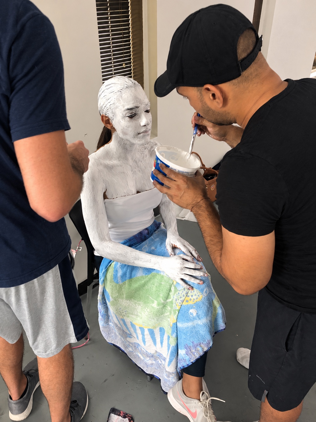 Rafael Montalvo body painting a model for Fiore Nera